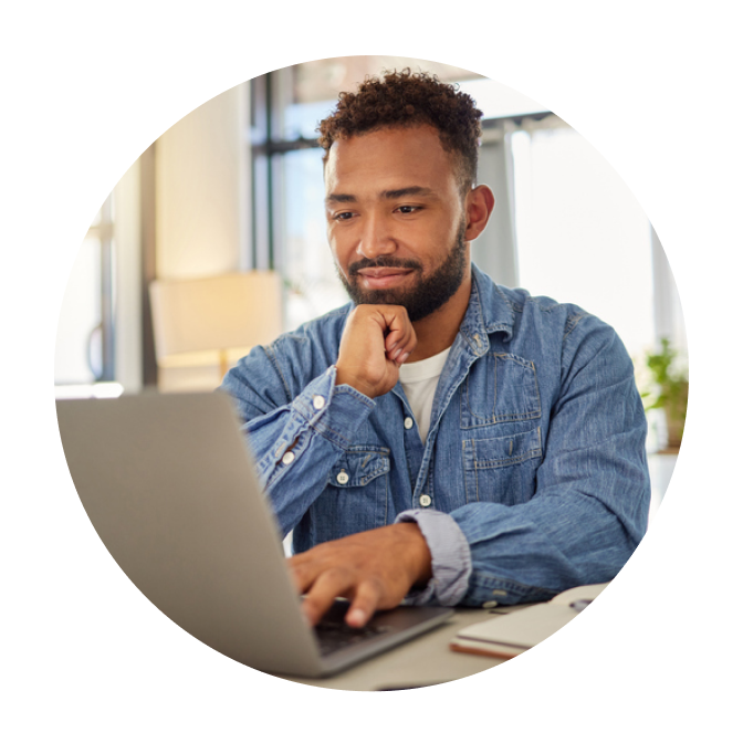 Person working on laptop at desk.