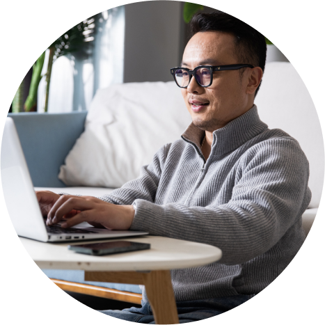 Man typing on laptop at home