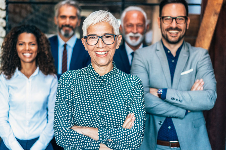 Diverse group of professionals smiling confidently.