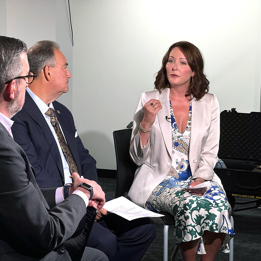 Three people having a discussion in a meeting.