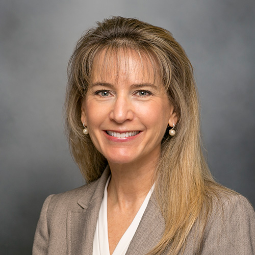 Professional woman smiling in business attire