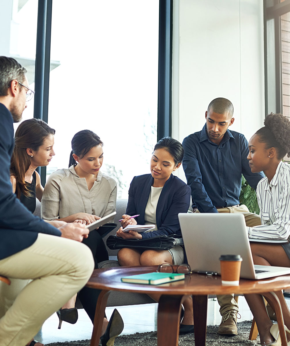 Diverse team collaborating around a table.