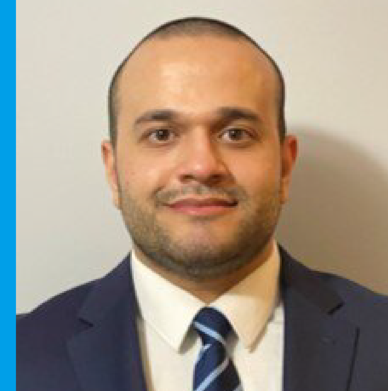 Smiling man in a suit and tie.