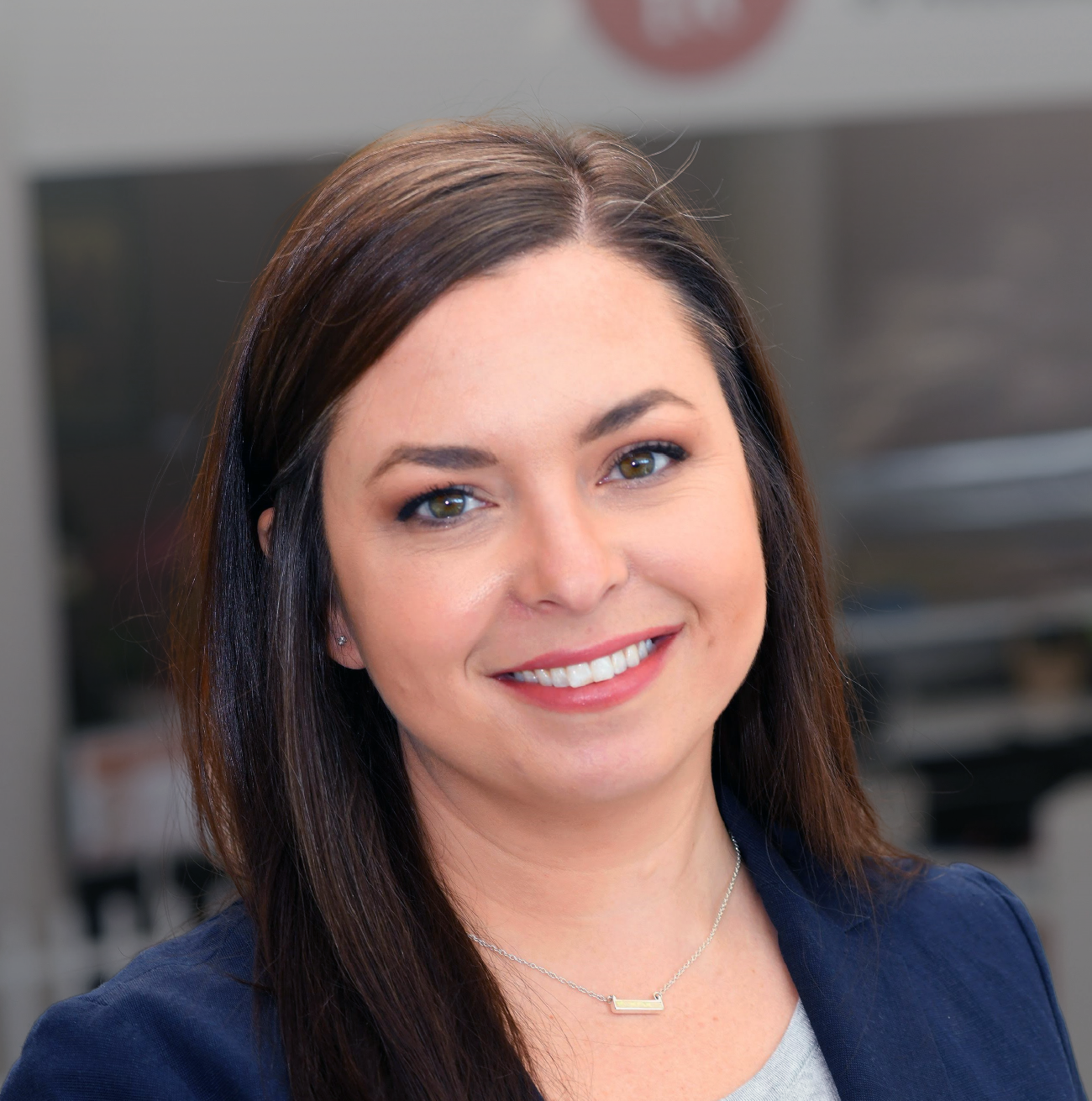 Smiling woman with brown hair and blue jacket