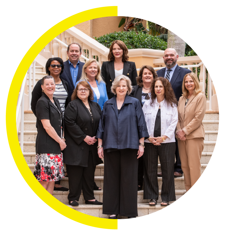 Group of professionals posing on stairs.